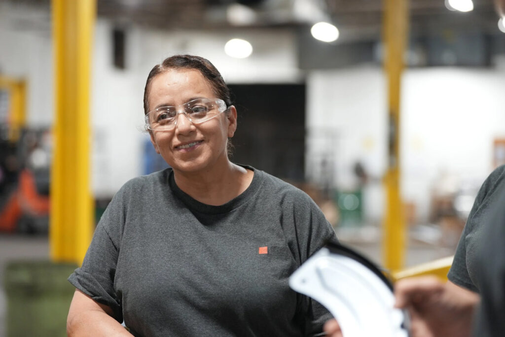 Smiling CCS Finishing employee in safety glasses