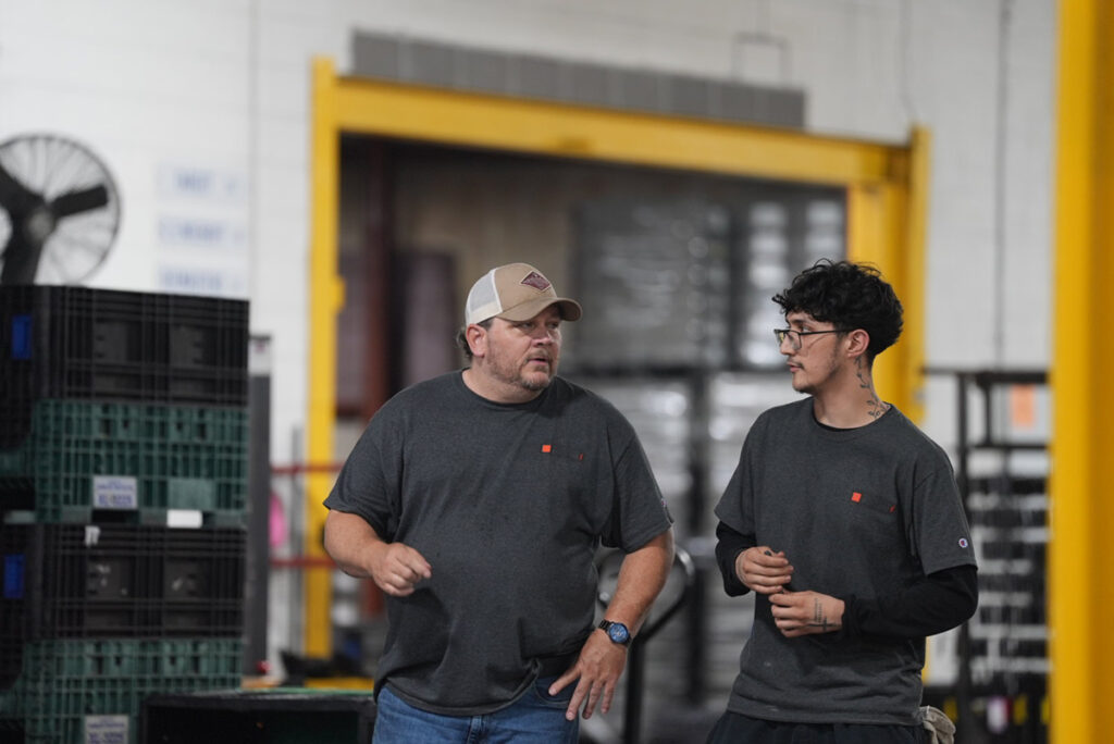 Young and old CCS Finishing employees talking