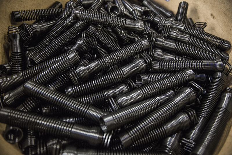 A close-up view of a pile of black oxide springs 