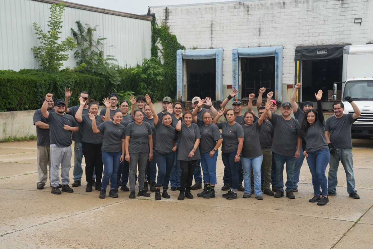 Staff posing outside enameled Steel facility