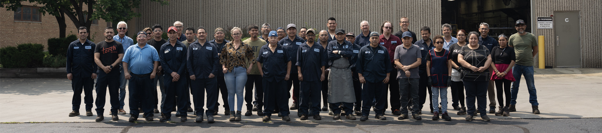 CCS Finishing Group employee's pose for photo outside facility
