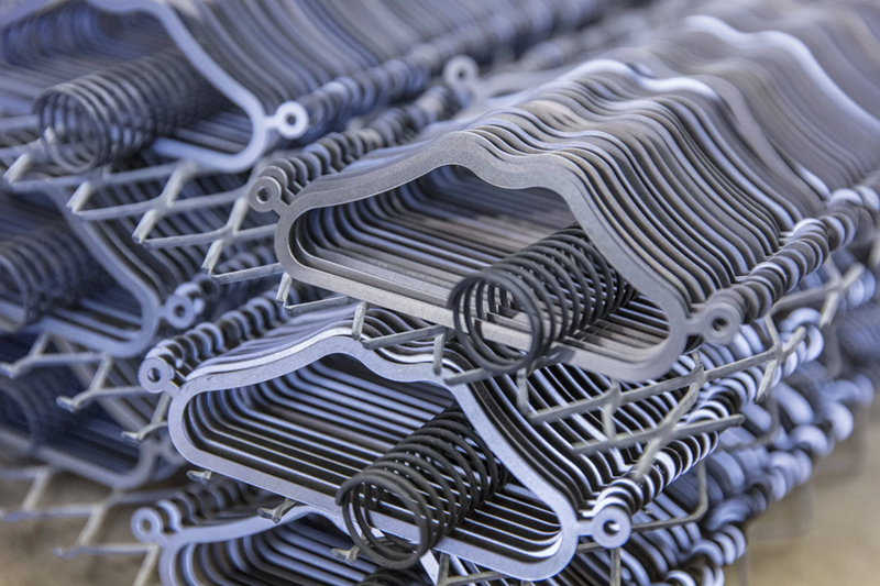 A close-up view of neatly stacked zinc phosphate components