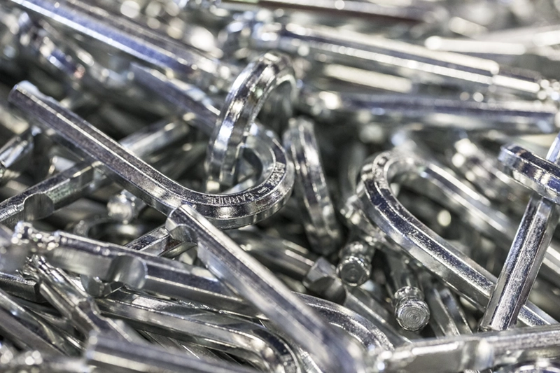 A close-up view of a pile of shiny zin-plated U-bolts,